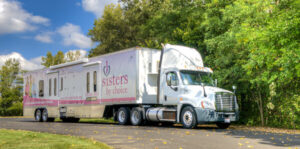 A large white semi-truck with a trailer labeled 