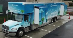 A large blue and white OhioHealth medical truck labeled 