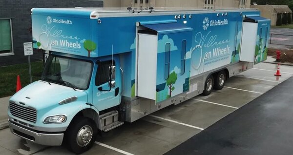 A large blue and white OhioHealth medical truck labeled 