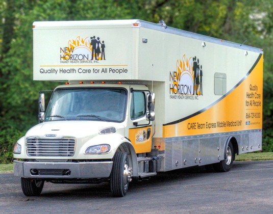 A large white and yellow mobile medical unit labeled 